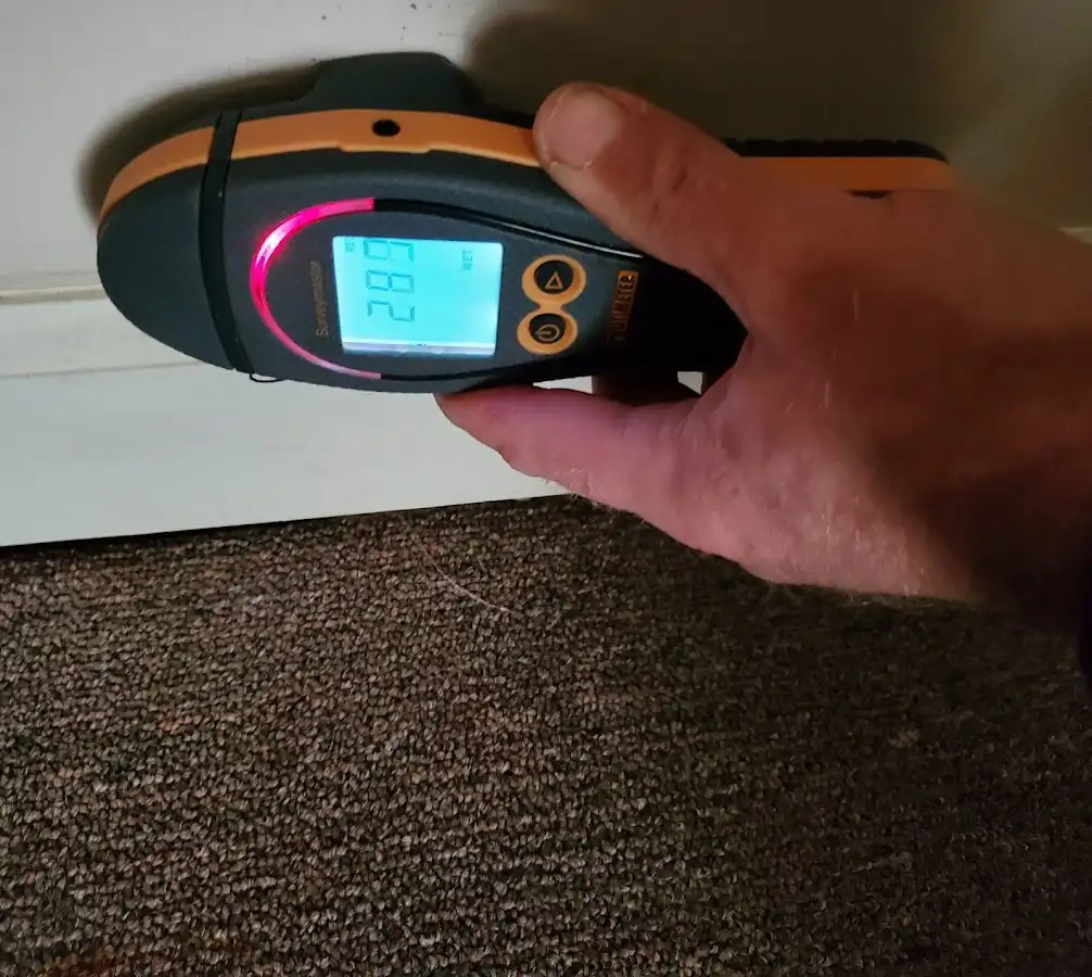 Moisture detection at baseboard during Storm Damage Restoration in Vernon